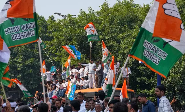 Workers of India's opposition Congress party shout slogans atop a bus as they gather for a march toward the Supreme Court demanding the resignation of Chief Election Commissioner Gyanesh Kumar in New Delhi, India, Monday, Oct. 12, 2026. (AP Photo/Manish Swarup)