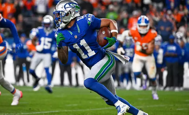 Seattle Seahawks wide receiver Jaxon Smith-Njigba runs the ball against the Denver Broncos during the second half of an NFL football game in Denver, Thursday, Oct. 15, 2026. (AP Photo/Geneva Heffernan)