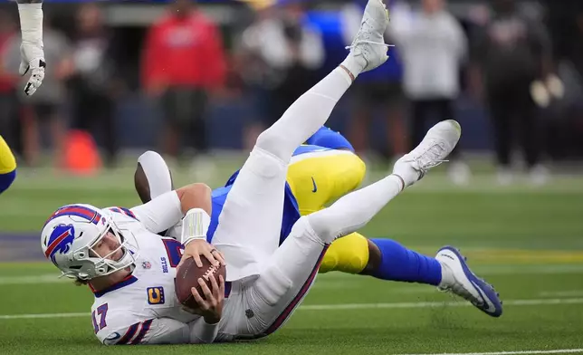 Buffalo Bills quarterback Josh Allen, left, is sacked by Los Angeles Rams linebacker Josaiah Stewart during the first half of an NFL football game, Monday, Oct. 12, 2026, in Inglewood, Calif. (AP Photo/Scott Strazzante)