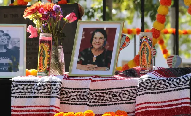 A collection of photographs, candles and flowers adorn an altar in honor of Dolores Huerta at Old Town Plaza in Albuquerque, New Mexico, Wednesday, Oct. 28, 2026. (AP Photo/Susan Montoya Bryan)