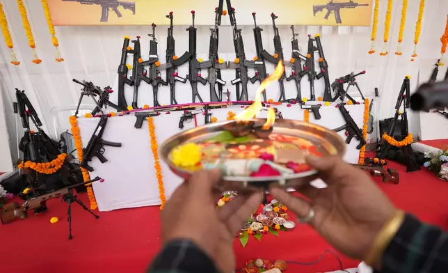A police officer performs rituals in front of weapons during worship of weapons at police headquarters on Vijayadashmi or Dussehra festival, in Ahmedabad, India, Tuesday, Oct. 20, 2026. (AP Photo/Ajit Solanki)