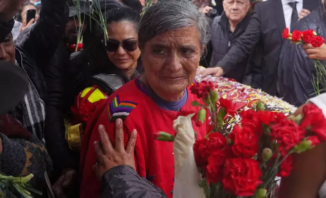 Silvia Solórzano grieves at a memorial service for her son Juan Francisco Solórzano Foppa, an anti-corruption lawyer who was slain last week, at Constitution Square in Guatemala City, Tuesday, Oct. 20, 2026. (AP Photo/Esteban Biba)