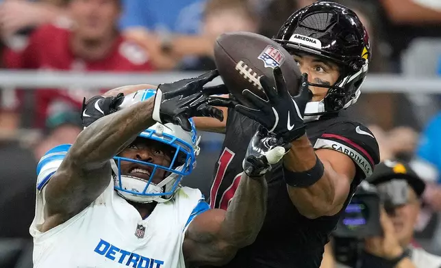 Detroit Lions cornerback D.J. Reed (4) breaks up a pass intended for Arizona Cardinals wide receiver Michael Wilson (14) during the second half of an NFL football game in Glendale, Ariz., Sunday, Oct. 11, 2026. (AP Photo/Ross D. Franklin)