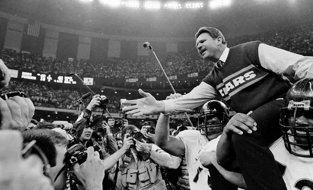 FILE - In this Jan. 26, 1986 file photo shows, Chicago Bears coach Mike Ditka reaches out to shake hands with New England Patriots coach Raymond Berry after the Bears won the NFL football Super Bowl XX game in New Orleans. (AP Photo/File)