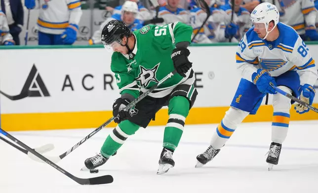 Dallas Stars center Wyatt Johnston (53) controls the puck in front of St. Louis Blues left wing Pavel Buchnevich (89) during the first period of an NHL hockey game Friday, Oct. 2, 2026, in Dallas. (AP Photo/Julio Cortez)