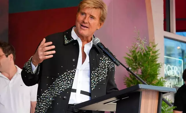 Steve Summers speaks outside Dolly Parton's Songteller Hotel during a gran opening ceremony Tuesday, Oct. 6, 2026, in Nashville, Tenn. (AP Photo/George Walker IV)