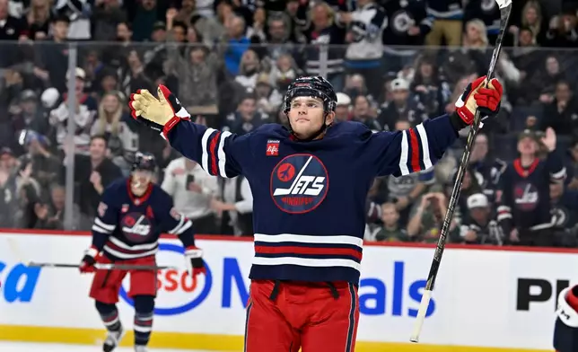 Winnipeg Jets' Cole Perfetti (91) celebrates his goal against the Minnesota Wild during second period NHL hockey action in Winnipeg, Manitoba, Tuesday, Oct. 13, 2026. (Fred Greenslade/The Canadian Press via AP)