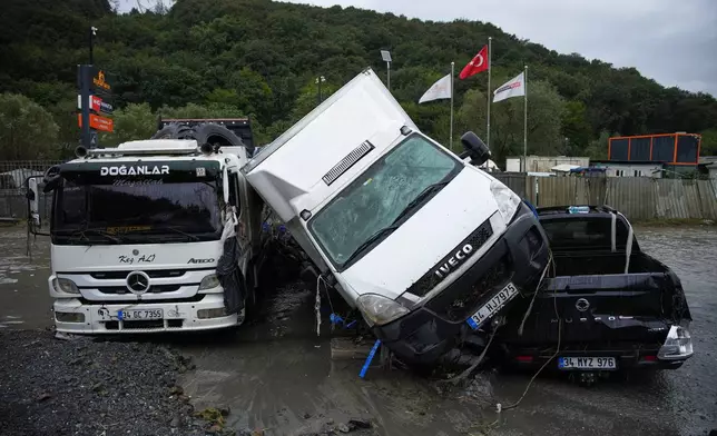 Vehicles lie scattered in the aftermath of flooding caused by heavy rains in Istanbul, Turkey, Thursday, Oct. 15, 2026. (AP Photo/Emrah Gurel)