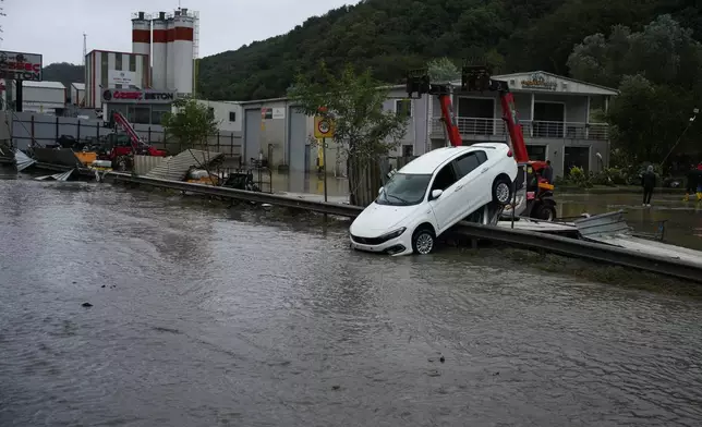 A car lies toppled in the aftermath of floods caused by heavy rains in Istanbul, Turkey, Thursday, Oct. 15, 2026. (AP Photo/Emrah Gurel)