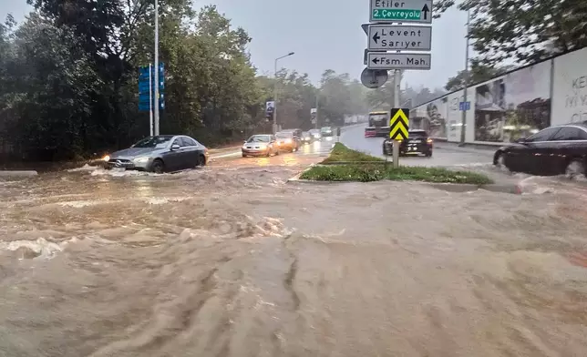Vehicles drive along a partially flooded road during a heavy rain in Istanbul, Turkey, Wednesday, Oct. 14, 2026. (Omer Hamza Yildiz/DIA Photo via AP)
