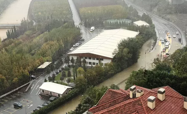Vehicles are seen next to a partially flooded highway during heavy rains in Istanbul, Turkey, Wednesday, Oct. 14, 2026. (AP Photo/Egecan Ozguner)
