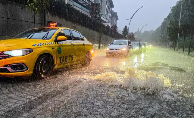 Vehicles drive along a partially flooded road during a heavy rain in Istanbul, Turkey, Wednesday, Oct. 14, 2026. (Omer Hamza Yildiz/DIA Photo via AP)