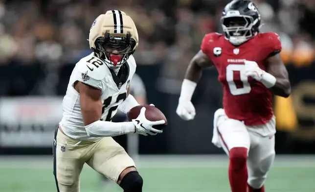 New Orleans Saints wide receiver Chris Olave (12) runs against Atlanta Falcons linebacker Divine Deablo (0) during the first half of an NFL football game in New Orleans, Monday, Oct. 5, 2026. (AP Photo/Gerald Herbert)