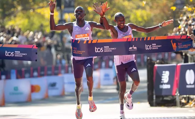 FILE - Benson Kipruto, left, edges out Alexander Mutiso at the finish line to win the men's elite division of the New York City Marathon, Sunday, Nov. 2, 2025, in New York. (AP Photo/Angelina Katsanis, File)
