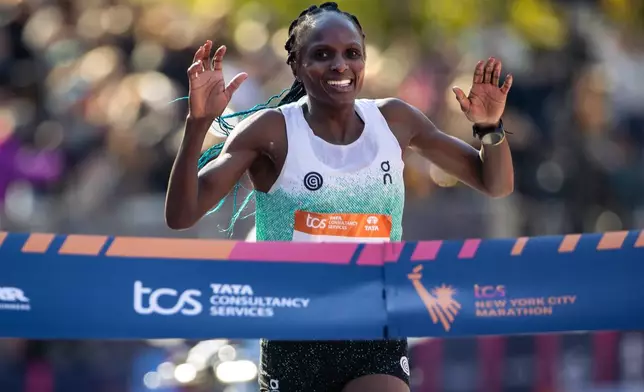 FILE - Hellen Obiri celebrates as she crosses the finish line first to win the women's elite division of the New York City Marathon, Sunday, Nov. 2, 2025, in New York. (AP Photo/Angelina Katsanis)