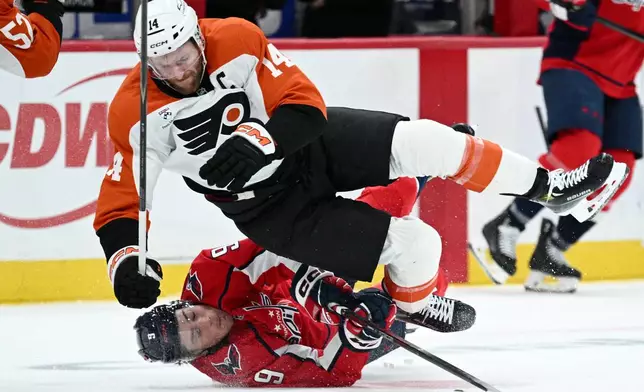 Washington Capitals right wing Ryan Leonard (9) collides with Philadelphia Flyers center Sean Couturier (14) during the second period of an NHL hockey game, Wednesday, Oct. 28, 2026, in Washington. (AP Photo/Nick Wass)