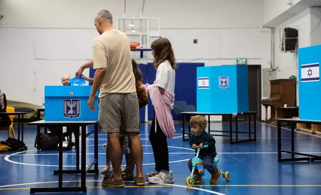 Voters cast their ballots at a polling station during Israel's general election in Jerusalem Tuesday, Oct. 27, 2026. (AP Photo/Ohad Zwigenberg)