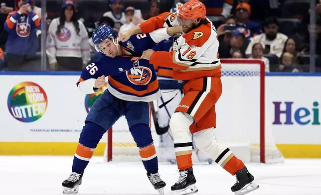 New York Islanders right wing Mitchell Chaffee (26) fights with Anaheim Ducks left wing A.J. Greer (18) during the second period of an NHL hockey game Tuesday, Oct. 20, 2026, in Elmont, N.Y. (AP Photo/Adam Hunger)