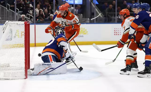 Anaheim Ducks right wing Frank Vatrano (77) scores a goal past New York Islanders goaltender Ilya Sorokin during the first period of an NHL hockey game Tuesday, Oct. 20, 2026, in Elmont, N.Y. (AP Photo/Adam Hunger)