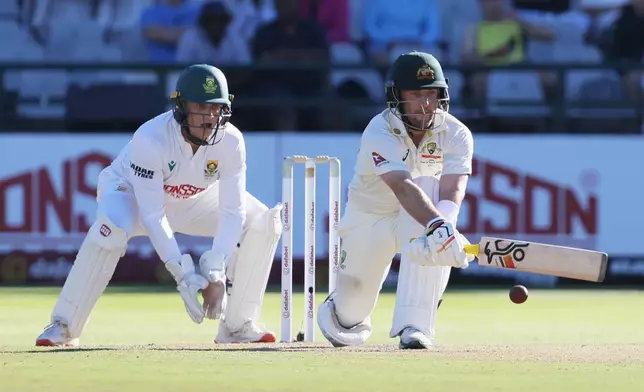 Australia's Josh Inglis plays a sweep shot as South Africa's wicketkeeper Ryan Rickelton watches on day two of the third cricket test match between South Africa and Australia, in Cape Town, South Africa, Wednesday, Oct. 28, 2026. (AP Photo/Halden Krog)