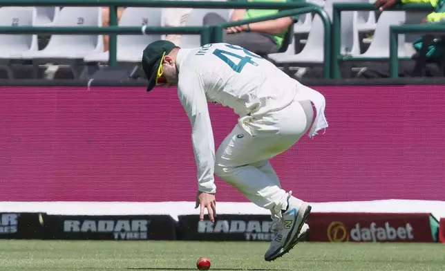 Australia's Josh Inglis fields the ball on day one of the third cricket test match between South Africa and Australia in Cape Town, South Africa, Tuesday, Oct. 27, 2026. (AP Photo/Halden Krog)