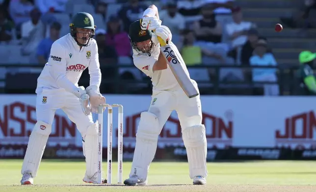 Australia's Josh Inglis plays a shot as South Africa's wicketkeeper Ryan Rickelton watches on day two of the third cricket test match between South Africa and Australia, in Cape Town, South Africa, Wednesday, Oct. 28, 2026. (AP Photo/Halden Krog)