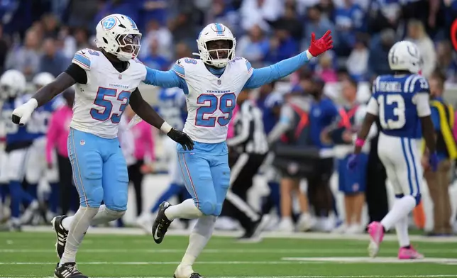 Tennessee Titans linebacker Anthony Hill Jr. (53) and safety Tony Adams (29) celebrate a fourth down defensive stop during the second half of an NFL football game against the Indianapolis Colts, Sunday, Oct. 18, 2026, in Indianapolis. (AP Photo/Jeff Roberson)