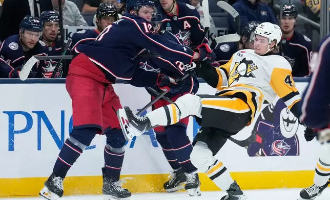 Columbus Blue Jackets left wing Dmitri Voronkov (10) checks Pittsburgh Penguins right wing Ville Koivunen, right, in the third period of an NHL hockey game in Columbus, Ohio, Friday, Oct. 9, 2026. (AP Photo/Sue Ogrocki)