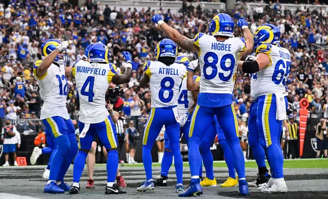 Los Angeles Rams wide receiver Puka Nacua, far left, celebrates after scoring a touchdown with teammates during the first half of an NFL football game against the Las Vegas Raiders, Sunday, Oct. 25, 2026, in Las Vegas. (AP Photo/David Becker)