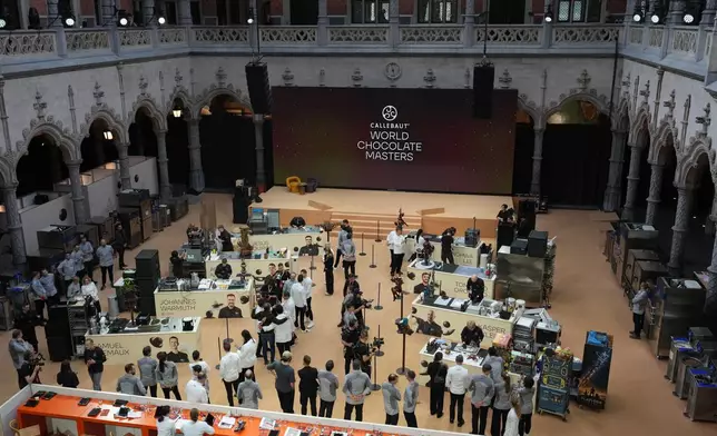 Chocolate artisans compete on the main floor during the World Chocolate Masters event in Antwerp, Belgium, Monday, Oct. 26, 2026. (AP Photo/Virginia Mayo)