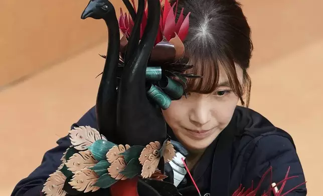Sanghwa Lee, of South Korea, competes with her chocolate creation depicting a bird and vase during the World Chocolate Masters event in Antwerp, Belgium, Monday, Oct. 26, 2026. (AP Photo/Virginia Mayo)