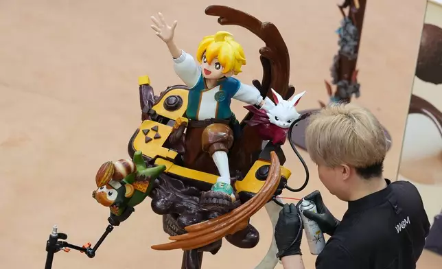 Keita Koshimizu, of Japan, competes with his chocolate creation during the World Chocolate Masters event in Antwerp, Belgium, Monday, Oct. 26, 2026. (AP Photo/Virginia Mayo)