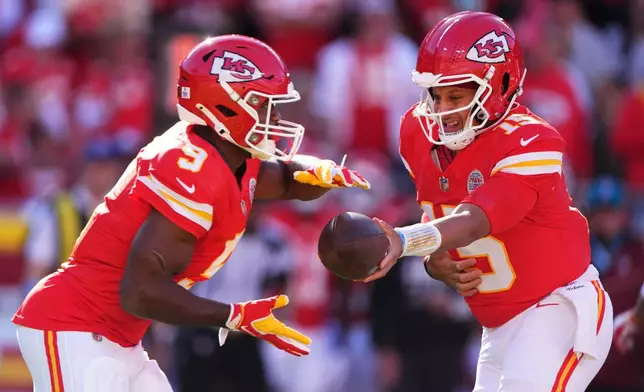 Kansas City Chiefs running back Kenneth Walker III (9) takes the hand off from quarterback Patrick Mahomes, right, during the first half of an NFL football game against the Los Angeles Chargers in Kansas City, Mo., Sunday, Oct. 18, 2026. (AP Photo/Charlie Riedel)