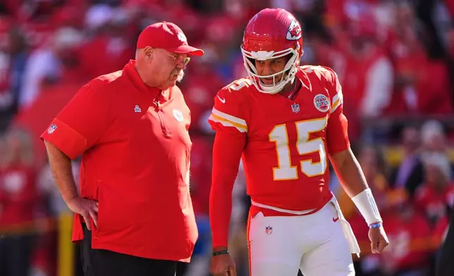 Kansas City Chiefs head coach Andy Reid, left, talks with quarterback Patrick Mahomes (15) during warmups before an NFL football game against the Los Angeles Chargers in Kansas City, Mo., Sunday, Oct. 18, 2026. (AP Photo/Charlie Riedel)