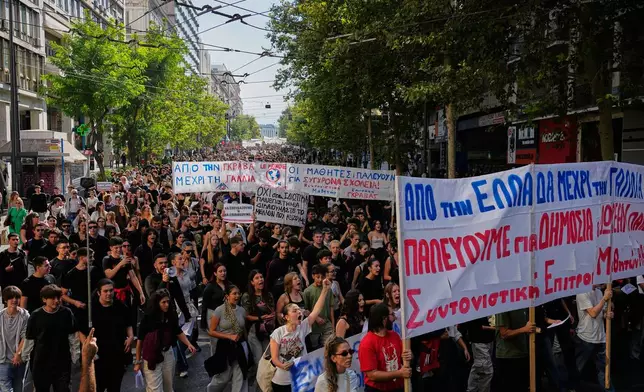 Protesters take part in a rally organized by teachers and students demanding improvements to education and measures to address the rising cost of living in Athens, Greece, Wednesday, Oct. 21, 2026. (AP Photo/Thanassis Stavrakis)