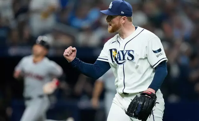 Tampa Bay Rays pitcher Drew Rasmussen celebrates the last out in the top of the third inning against the Cleveland Guardians in Game 1 of an American League Championship Series baseball game in St. Petersburg, Fla. Monday, Oct. 12, 2026. (AP Photo/David J. Phillip)