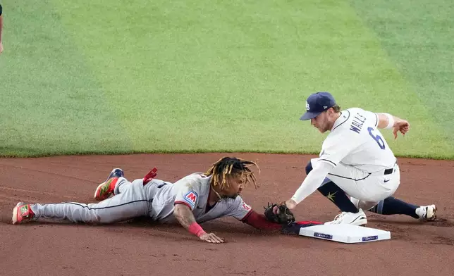 Cleveland Guardians' José Ramírez is tagged out by Tampa Bay Rays shortstop Taylor Walls stealing during the first inning in Game 1 of an American League Championship Series baseball game in St. Petersburg, Fla. Monday, Oct. 12, 2026. (AP Photo/Chris O'Meara)