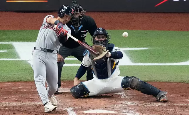 Cleveland Guardians' Steven Kwan singles against the Tampa Bay Rays during the third inning in Game 1 of an American League Championship Series baseball game in St. Petersburg, Fla. Monday, Oct. 12, 2026. (AP Photo/Chris O'Meara)