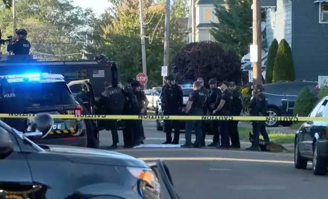 Law enforcement officers remain at the scene of a deadly shooting that occurred Friday night in Erie, Pa., on Saturday, Oct. 10, 2026.(WJET via AP)