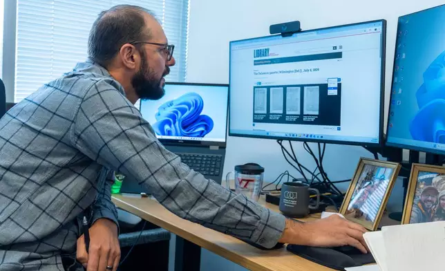 Smithsonian's Data Scientist Mike Trizna, looks on a computer monitor at a July 8, 1809 ,edition of the The Delaware Gazette from Wilmington, Del., as he works Sept. 29, 2026, in Washington. (AP Photo/Manuel Balce Ceneta)