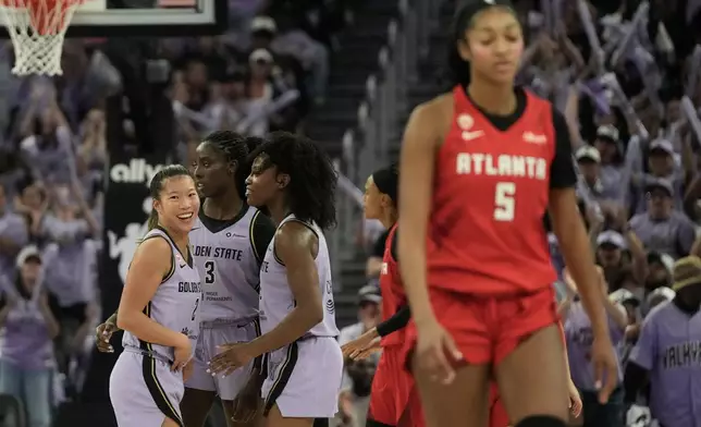 Golden State Valkyries guard Kaitlyn Chen, left, celebrates with forward Laeticia Amihere (3) and guard-forward Kaila Charles as Atlanta Dream forward Angel Reese (5) walks toward the bench during the second half of Game 1 of the WNBA basketball finals, Saturday, Oct. 17, 2026, in San Francisco. (AP Photo/Jeff Chiu)