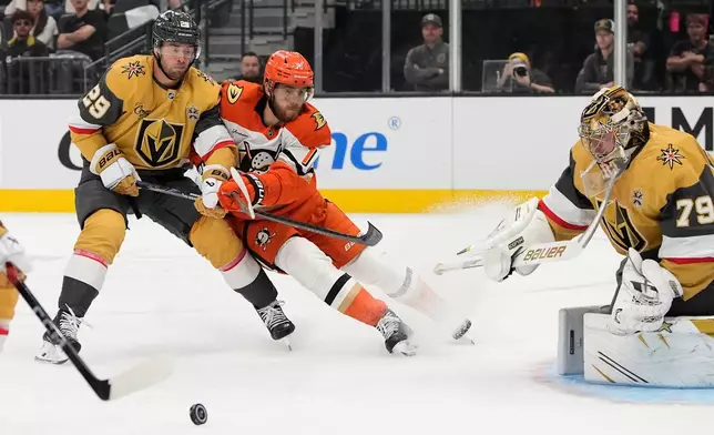 Vegas Golden Knights defenseman Parker Wotherspoon (29) and Anaheim Ducks left wing A.J. Greer (18) battle for the puck during the first period of an NHL hockey game Friday, Oct. 2, 2026, in Las Vegas. (AP Photo/John Locher)