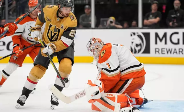 Vegas Golden Knights center Brett Howden (21) attempts a shot on Anaheim Ducks goaltender Lukas Dostal (1) during the second period of an NHL hockey game Friday, Oct. 2, 2026, in Las Vegas. (AP Photo/John Locher)