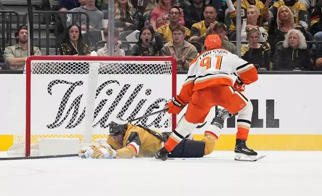 Anaheim Ducks center Leo Carlsson (91) scores against the Vegas Golden Knights during the second period of an NHL hockey game Friday, Oct. 2, 2026, in Las Vegas. (AP Photo/John Locher)