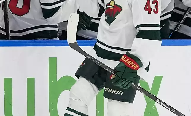 Minnesota Wild defenseman Quinn Hughes (43) celebrates with the bench after his goal against the Tampa Bay Lightning during the second period of an NHL hockey game Thursday, Oct. 8, 2026, in Tampa, Fla. (AP Photo/Chris O'Meara)
