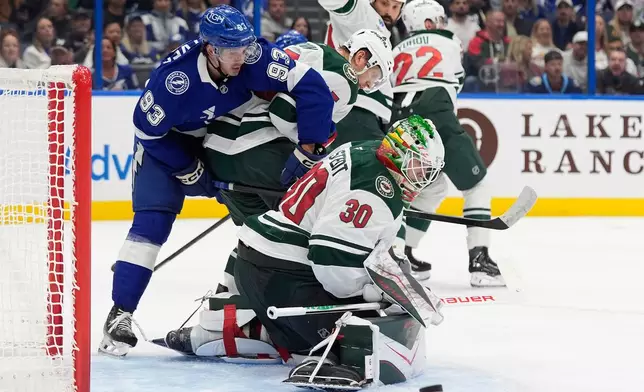 Minnesota Wild goaltender Jesper Wallstedt (30) stops a shot by Tampa Bay Lightning center Gage Goncalves (93) during the second period of an NHL hockey game Thursday, Oct. 8, 2026, in Tampa, Fla. (AP Photo/Chris O'Meara)