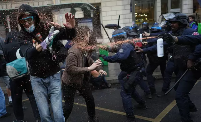 Police officers spray students with pepper spray near Sciences Po university as they protest against under-resourced schools, in Paris, Wednesday, Oct. 7, 2026. (AP Photo/Thibault Camus)