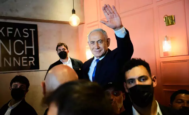 Israeli Prime Minister Benjamin Netanyahu, leader of the Likud party, waves to supporters during an election campaign in Dimona, southern Israel, Wednesday, Oct. 21, 2026. (AP Photo/Ohad Zwigenberg)