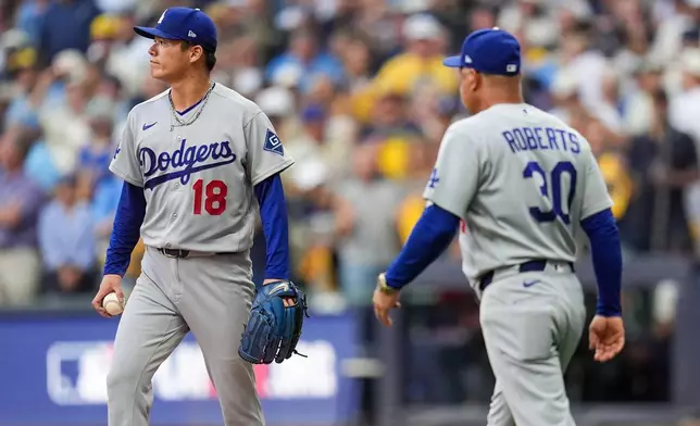 Los Angeles Dodgers manager Dave Roberts (30) pulls Los Angeles Dodgers pitcher Yoshinobu Yamamoto (18) from the game during the third inning of Game 2 of baseball's National League Championship Series between the Milwaukee Brewers and the Los Angeles Dodgers, Monday, Oct. 12, 2026, in Milwaukee. (AP Photo/Abbie Parr)