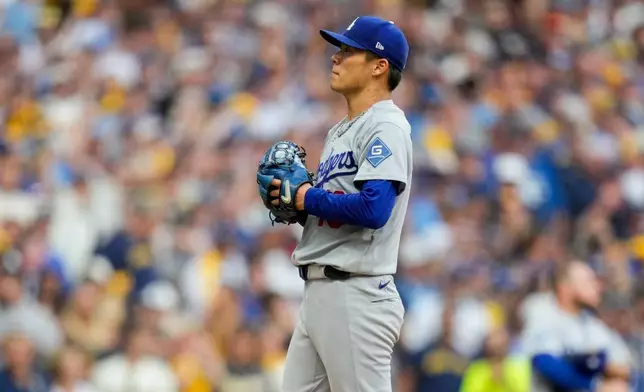 Los Angeles Dodgers pitcher Yoshinobu Yamamoto waits to be pulled from the game during the third inning of Game 2 of baseball's National League Championship Series between the Milwaukee Brewers and the Los Angeles Dodgers, Monday, Oct. 12, 2026, in Milwaukee. (AP Photo/Ashley Landis)